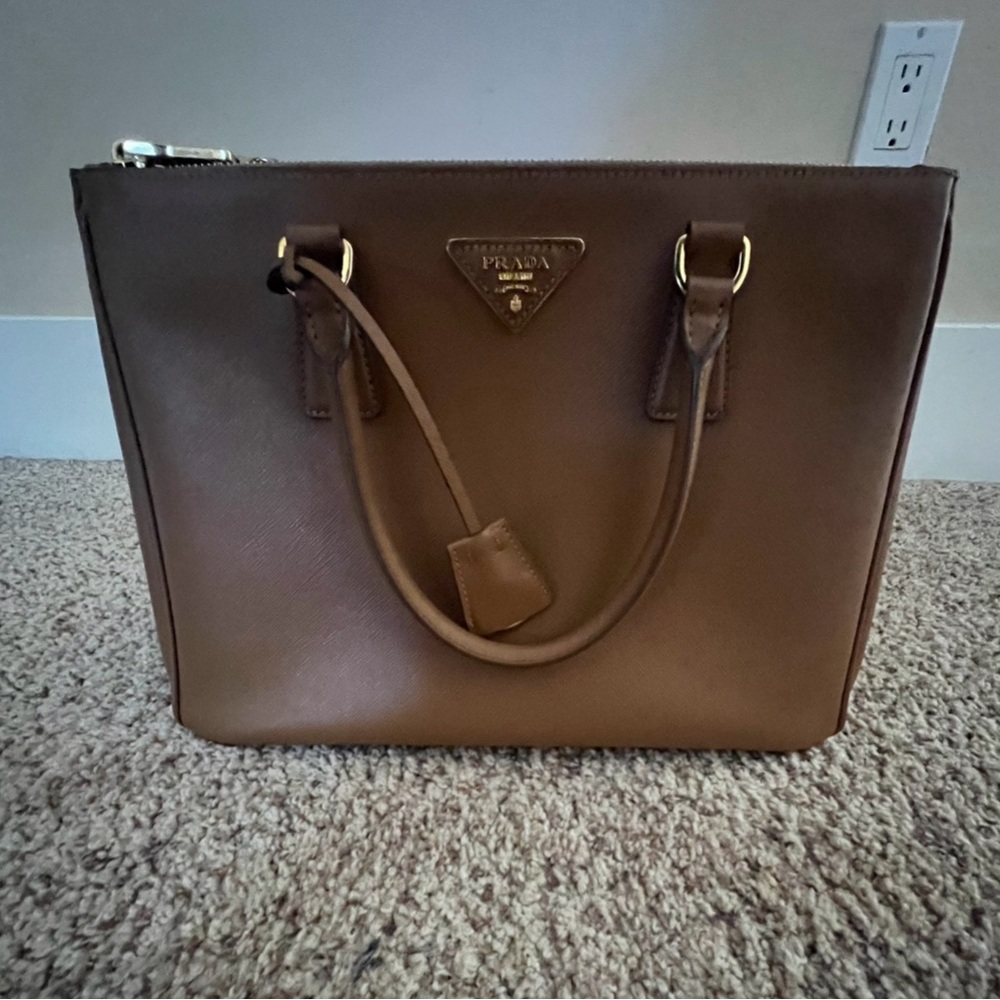 Prada handbag nearly brand new purchased for my mom she never uses it.